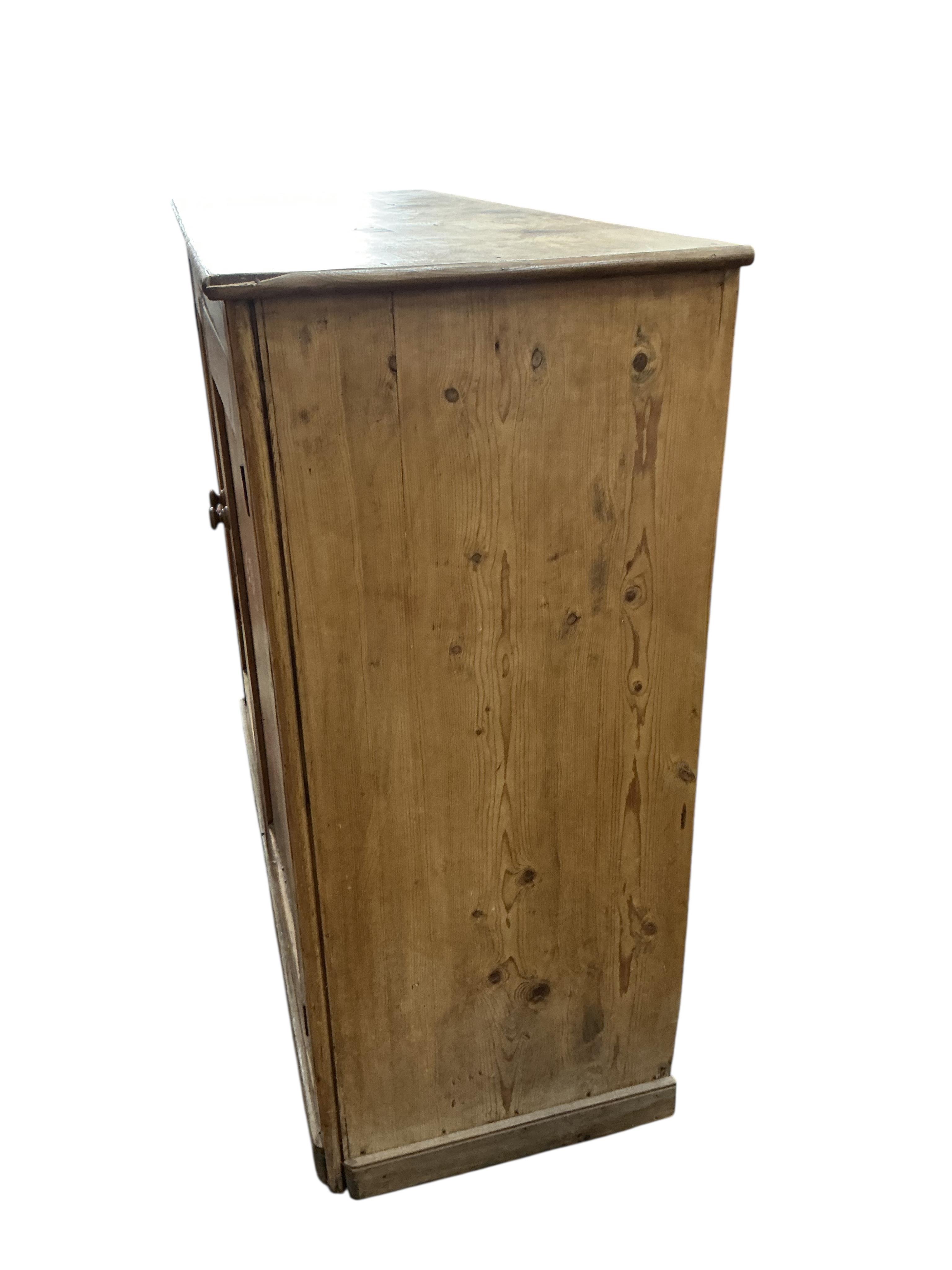 A Victorian pine side cabinet, width 131cm, depth 49cm, height 111cm